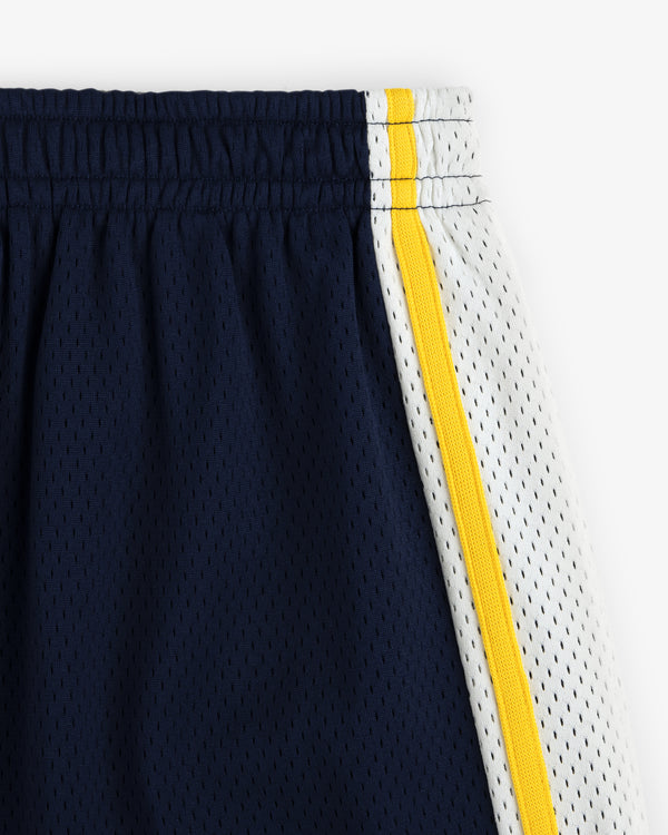 Close-up of Colorblock Court Short: navy mesh with white side panel, yellow stripe, and elastic waistband.