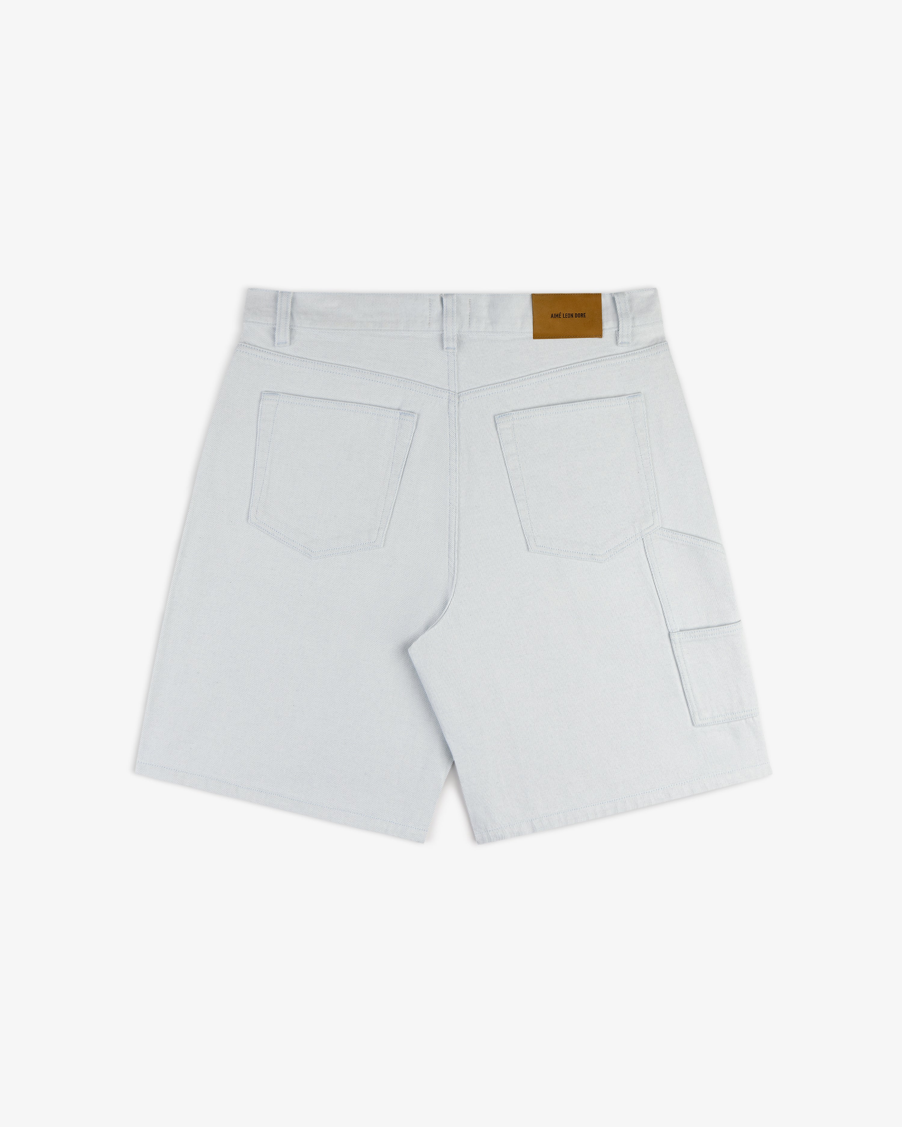 Light Wash Denim Short featuring back pockets and a brown waistband label, shown on a white background.