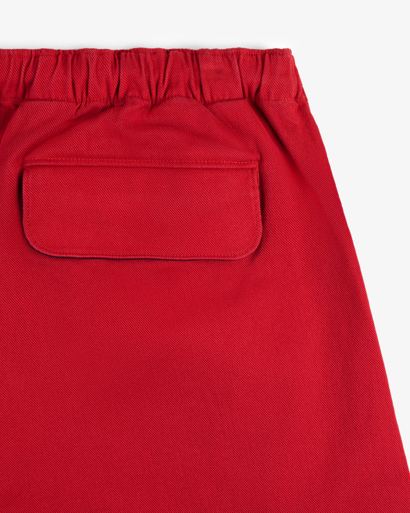 Close-up of Crest Casual Short in red, featuring an elastic waistband and a single flap back pocket.