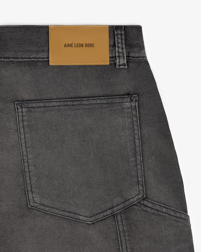 Close-up of a gray Garment Dyed Carpenter Short with a tan Aimé Leon Dore label above the pocket.
