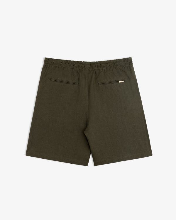 Back view of Linen Leisure Short in dark olive green with elastic waistband and two zippered pockets.