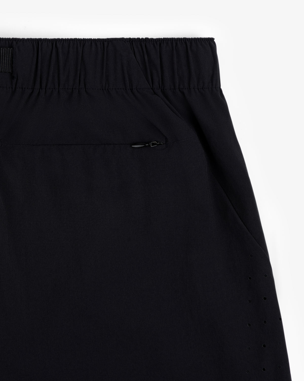 Close-up of ALD Golf Performance Short in black with elastic waistband, zip pocket, and side perforated holes.