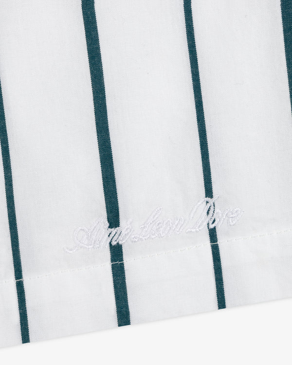 White poplin leisure shorts with vertical green stripes and white "American Dior" embroidery near the edge.