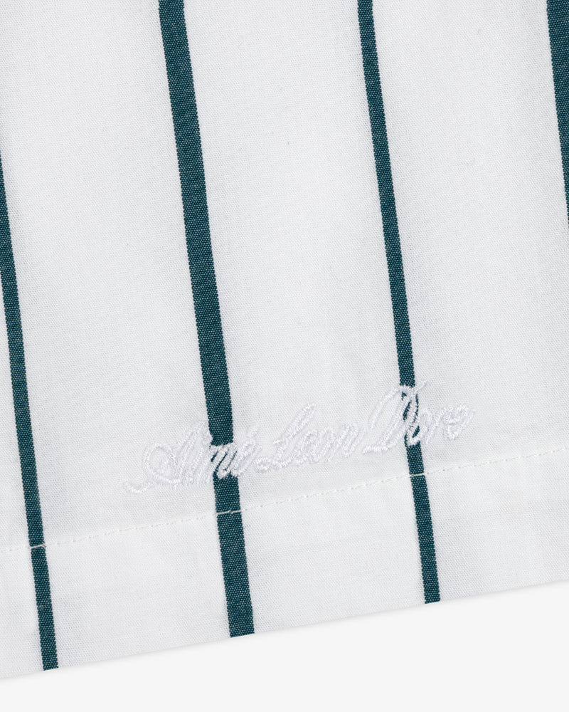 White poplin leisure shorts with vertical green stripes and white "American Dior" embroidery near the edge.