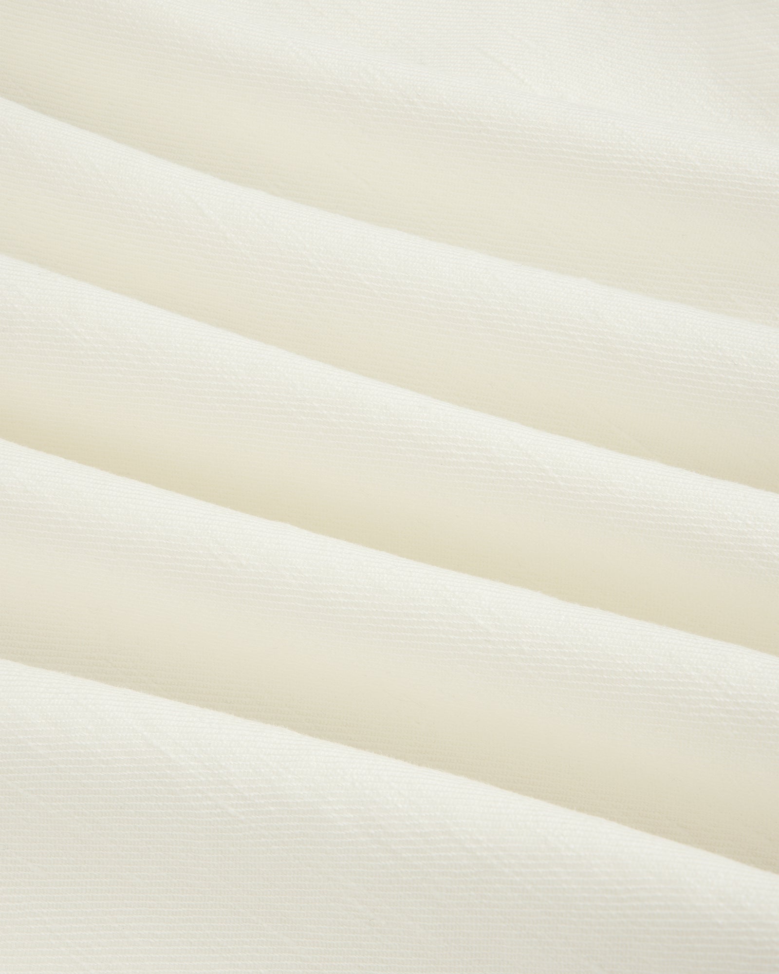 Cream-colored Pleated Linen Blend Bermuda Short with soft diagonal folds and a smooth, textured surface.