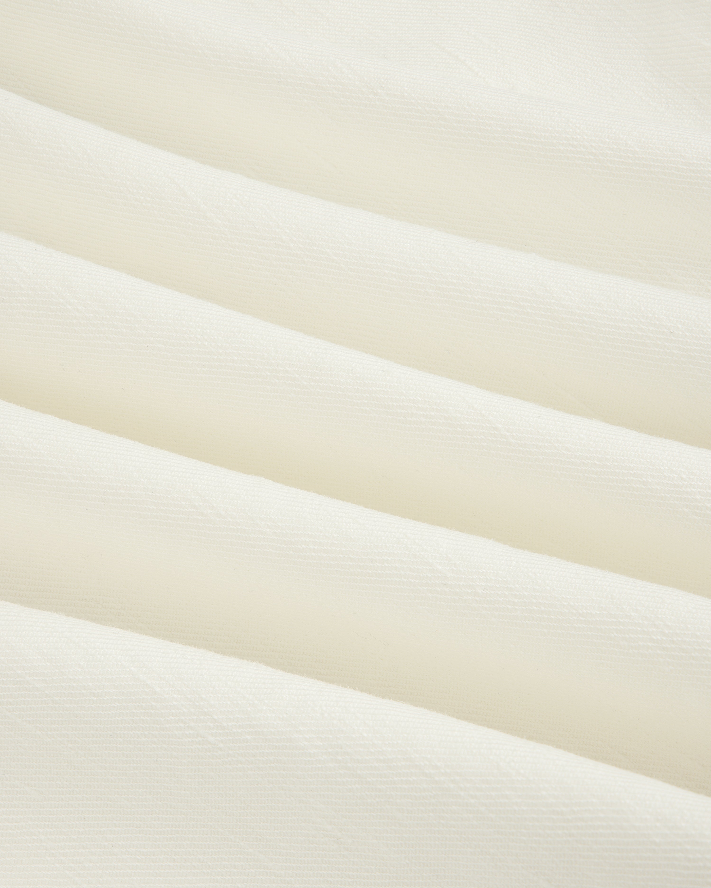 Cream-colored Pleated Linen Blend Bermuda Short with soft diagonal folds and a smooth, textured surface.