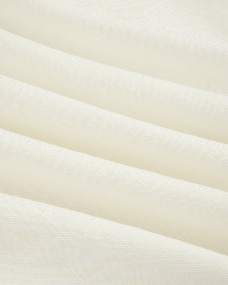 Cream-colored Pleated Linen Blend Bermuda Short with soft diagonal folds and a smooth, textured surface.