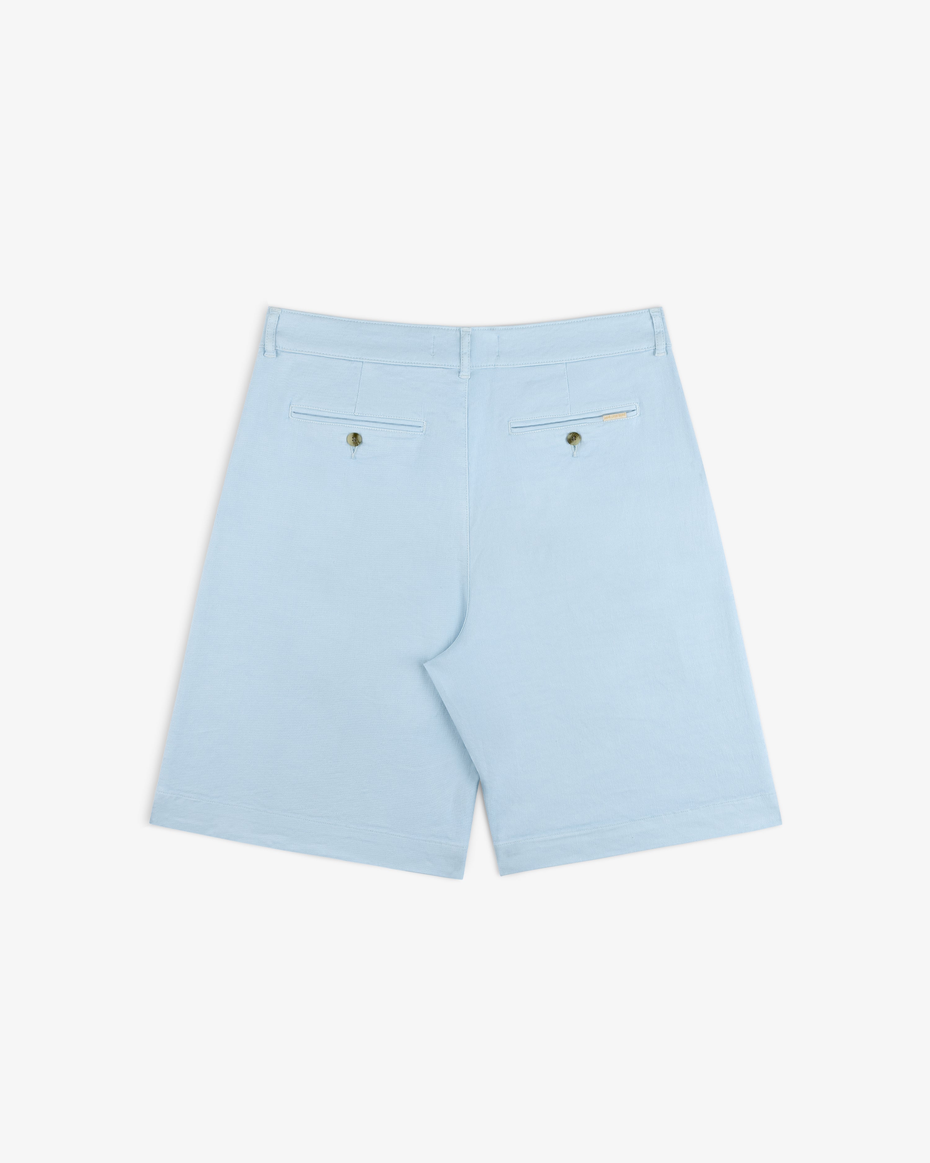 Pleated Linen Blend Bermuda Short in light blue, with two back pockets and button closures, shown on white background.