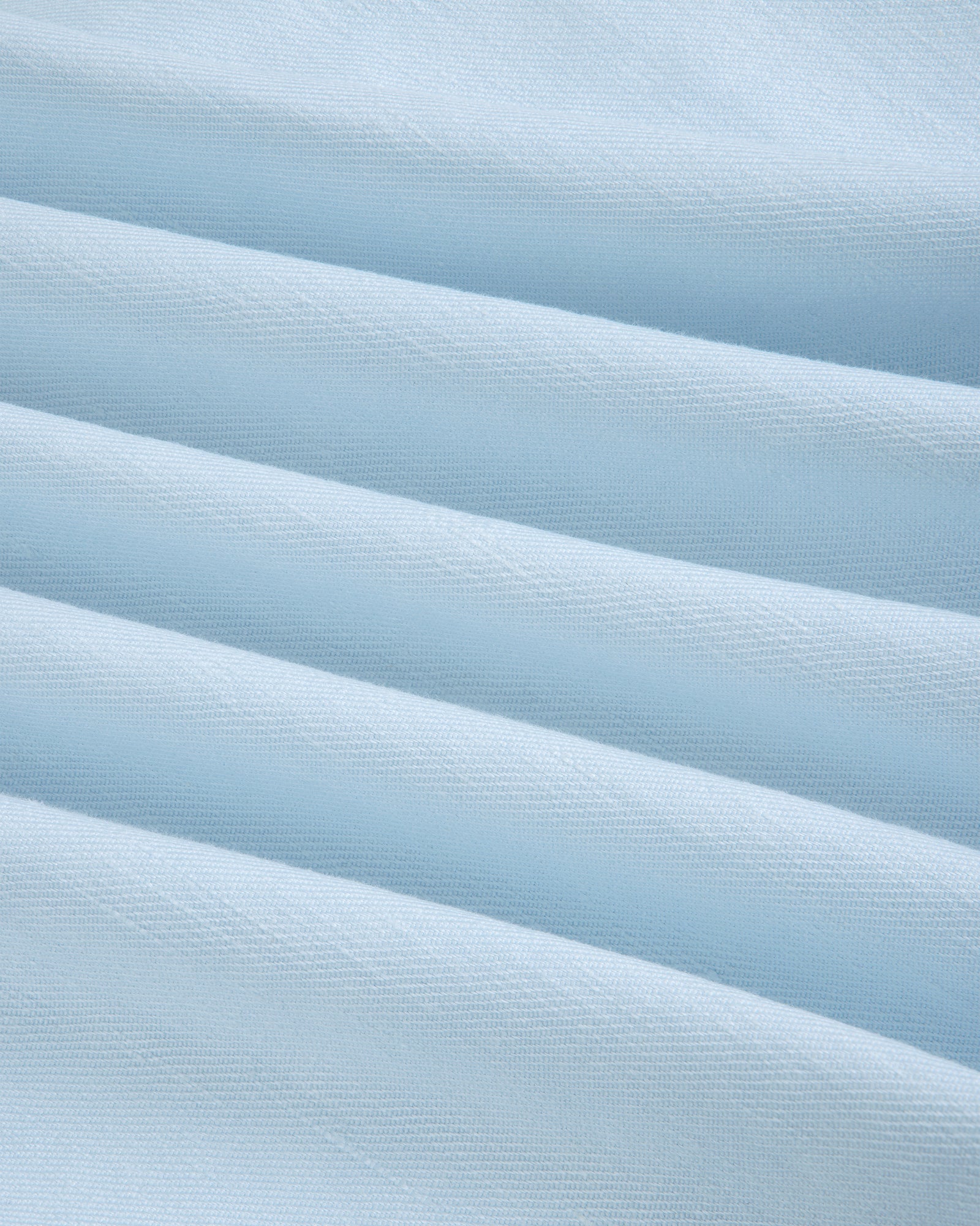 Light blue Pleated Linen Blend Bermuda Short with soft horizontal folds, smooth texture, and subtle shadows.