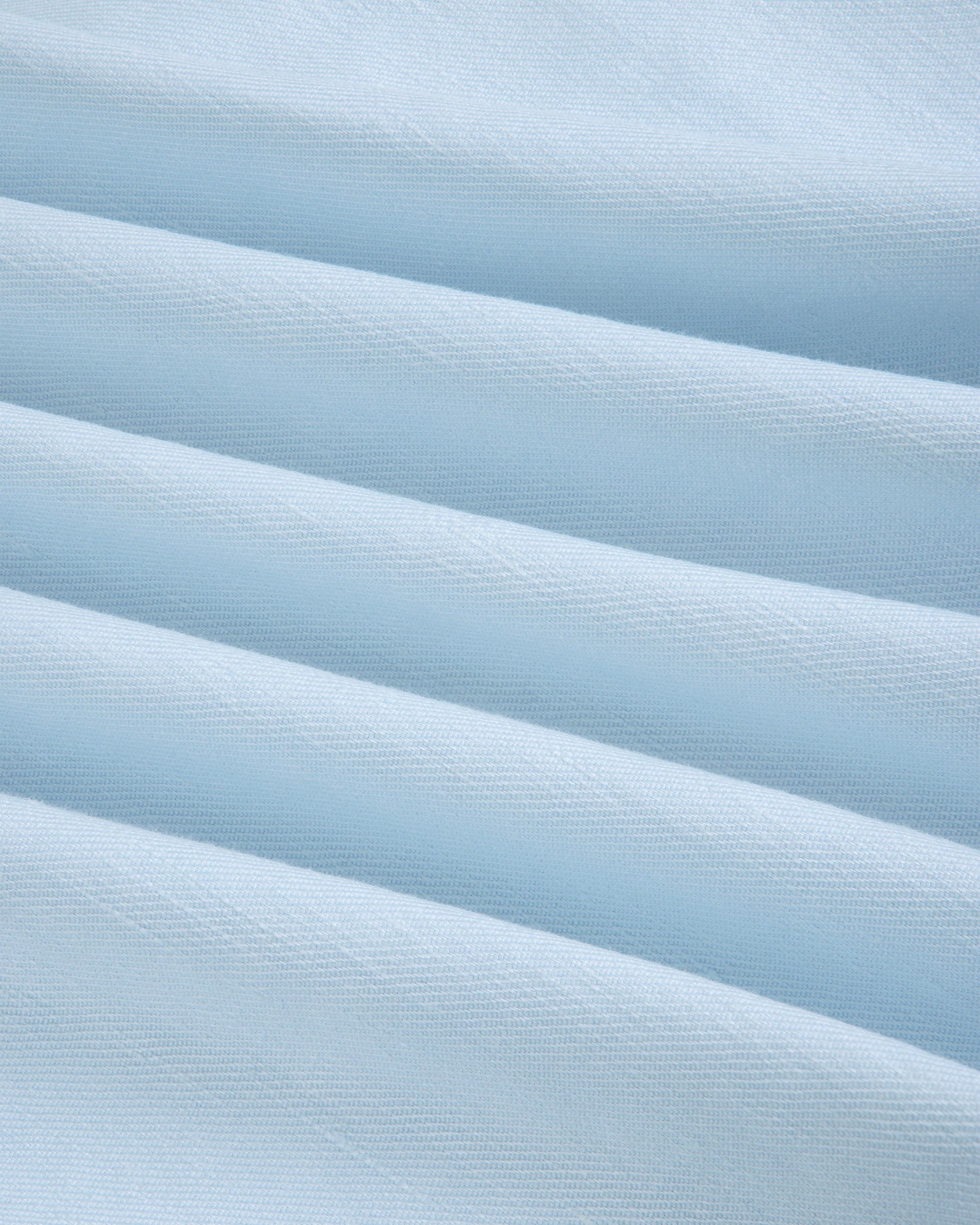 Light blue Pleated Linen Blend Bermuda Short with soft horizontal folds, smooth texture, and subtle shadows.