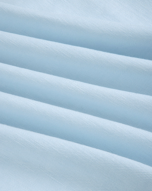 Light blue Pleated Linen Blend Bermuda Short with soft horizontal folds, smooth texture, and subtle shadows.