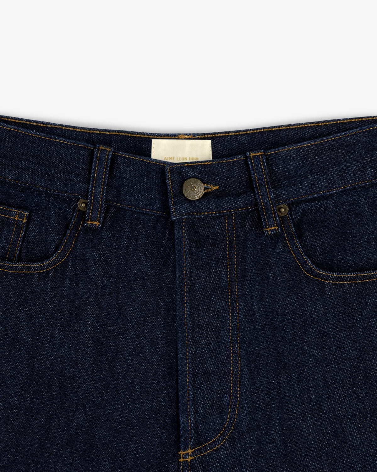 Close-up of the Rinse Wash Denim Short featuring a button closure and visible yellow stitching.