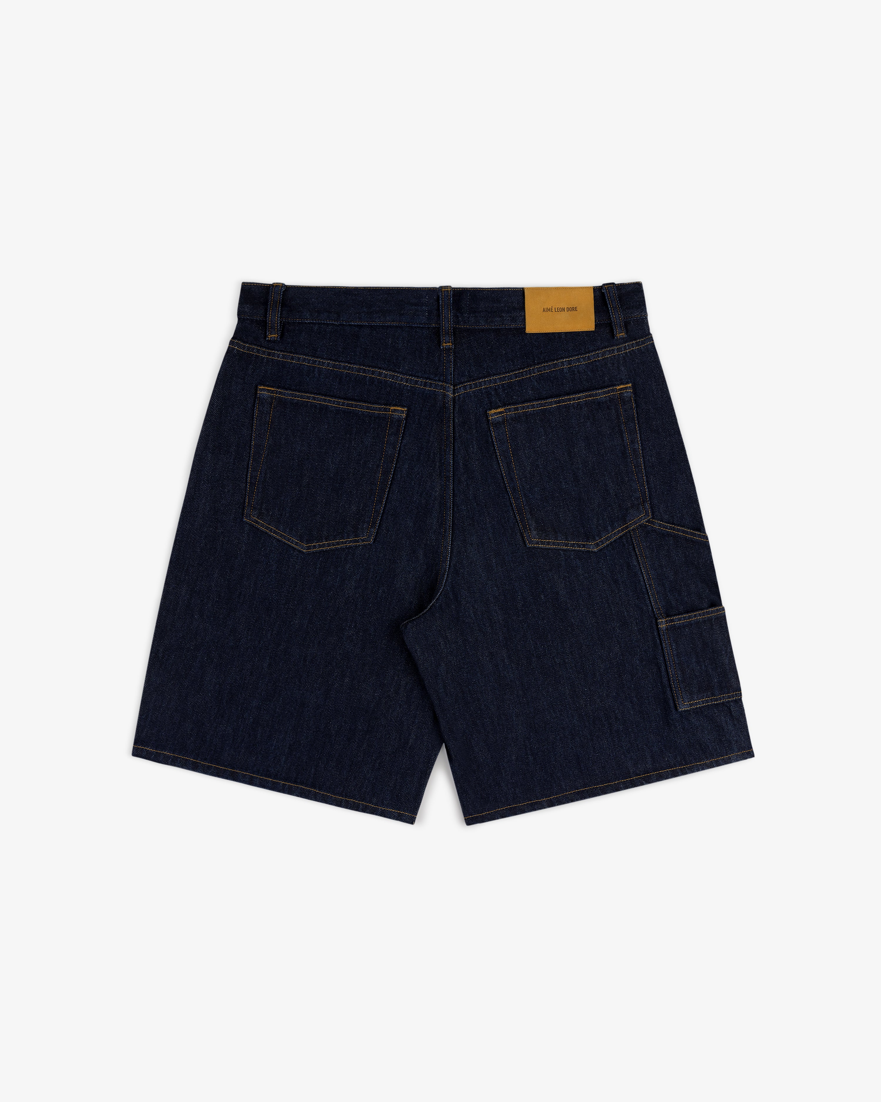 Back view of Rinse Wash Denim Short with contrast stitching, patch pockets, and a tan leather waistband label.