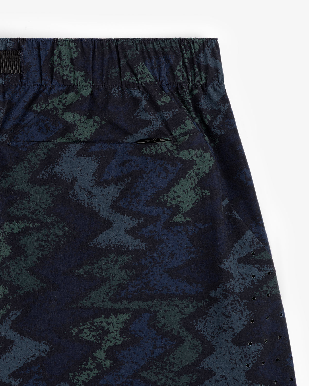 Close-up of ALD Golf Performance Short with dark green and blue zigzag fabric, elastic waistband, and small pocket.