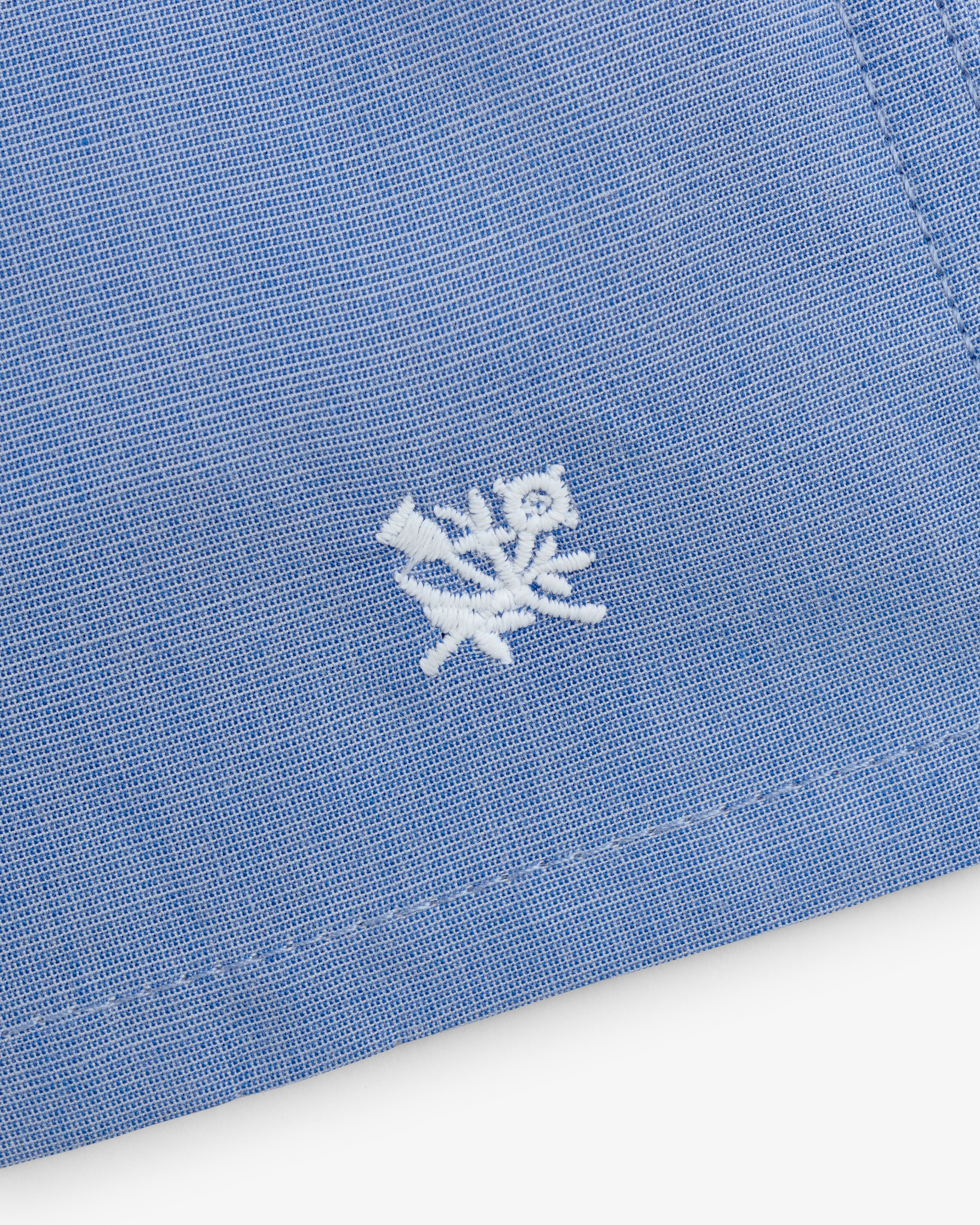 Close-up of Boxer Short 2-Pack in blue fabric with white embroidered floral design near the edge.