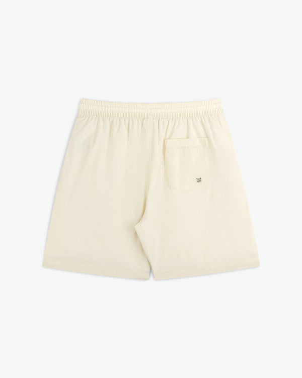 Back view of Long Nylon Track Short in cream, featuring an elastic waistband and a single right-side pocket.