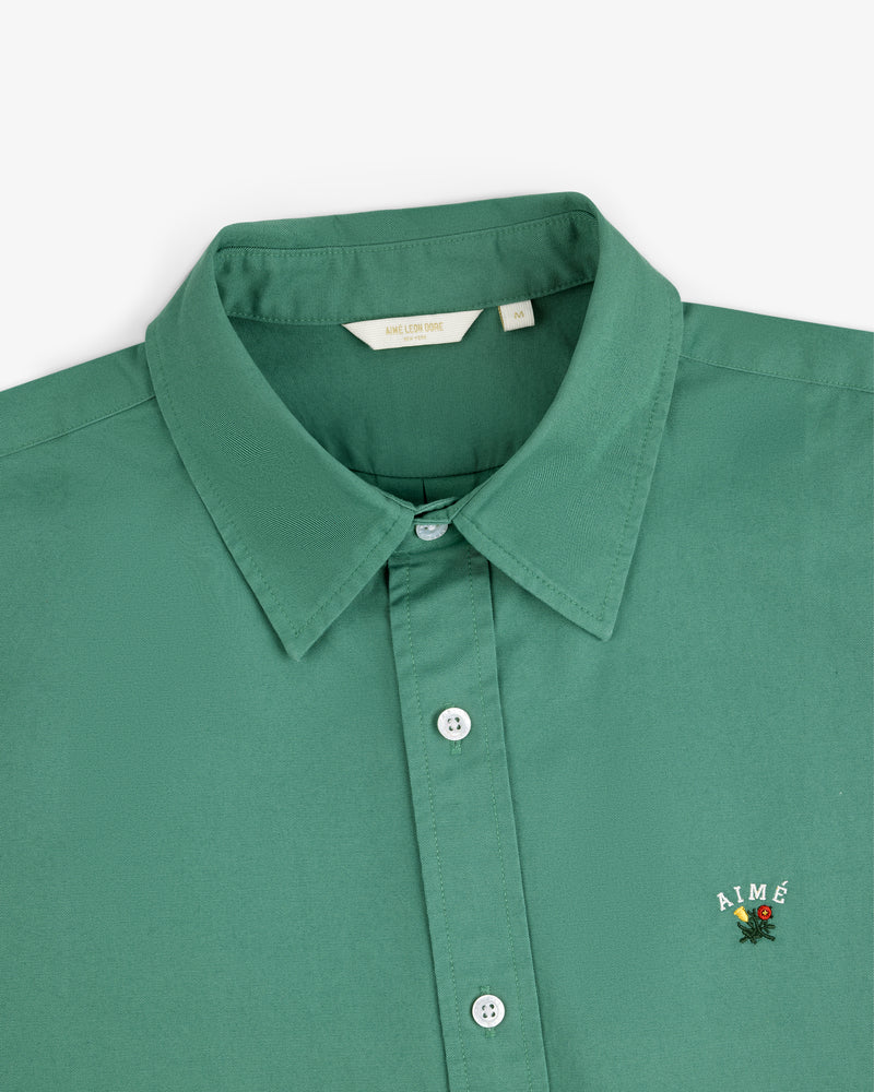 Leon Overshirt: Green collared button-up with AIMÉ and a small flower embroidered on the chest.