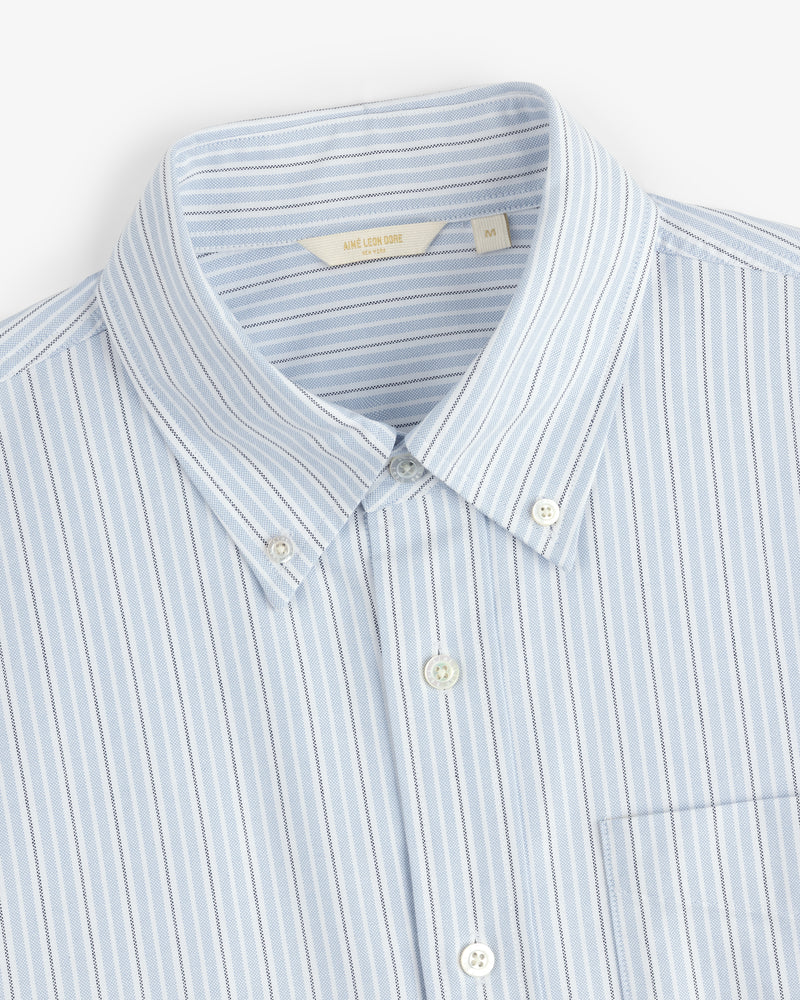 Yarn Dyed Striped Crest Shirt, light blue with white and blue vertical stripes, collar, chest pocket, size medium.