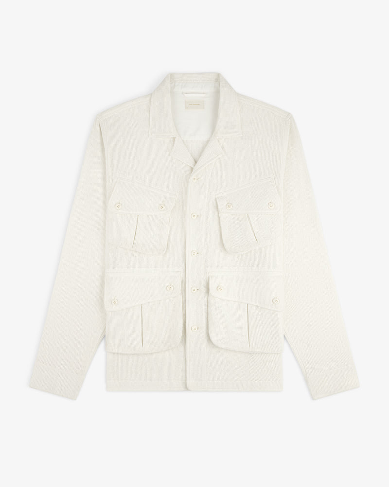 Mesh Jungle Shirt with collar and four front flap pockets, off-white and textured, laid flat on white background.