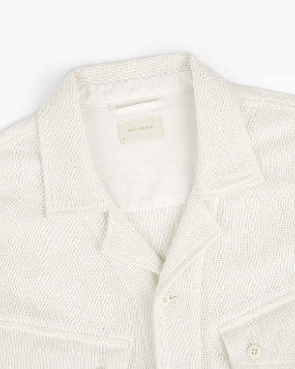 Mesh Jungle Shirt in cream, textured with front pockets, displayed from above on a white background.