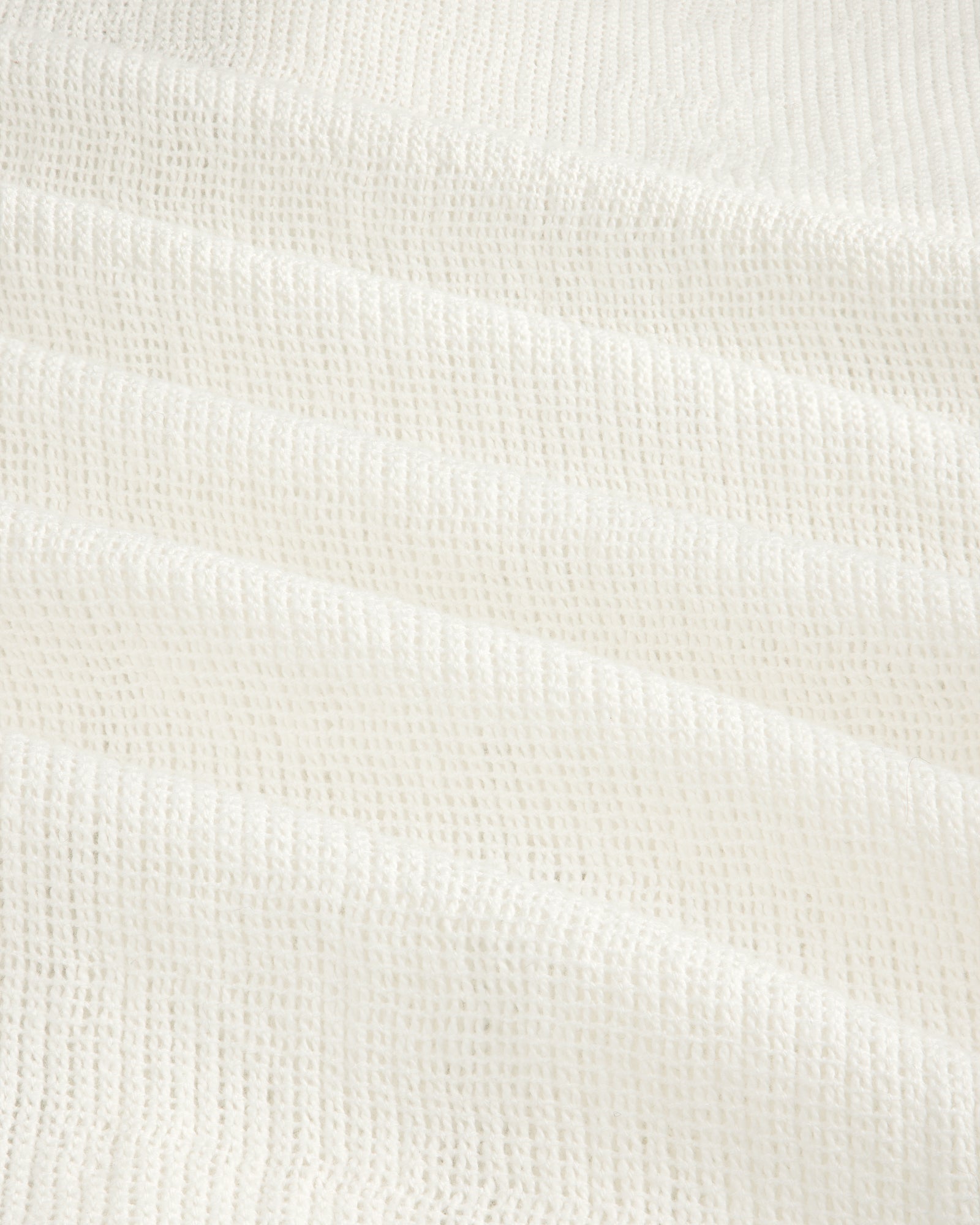 White textured waffle-weave fabric on the Mesh Jungle Shirt, shown in soft, gentle folds.
