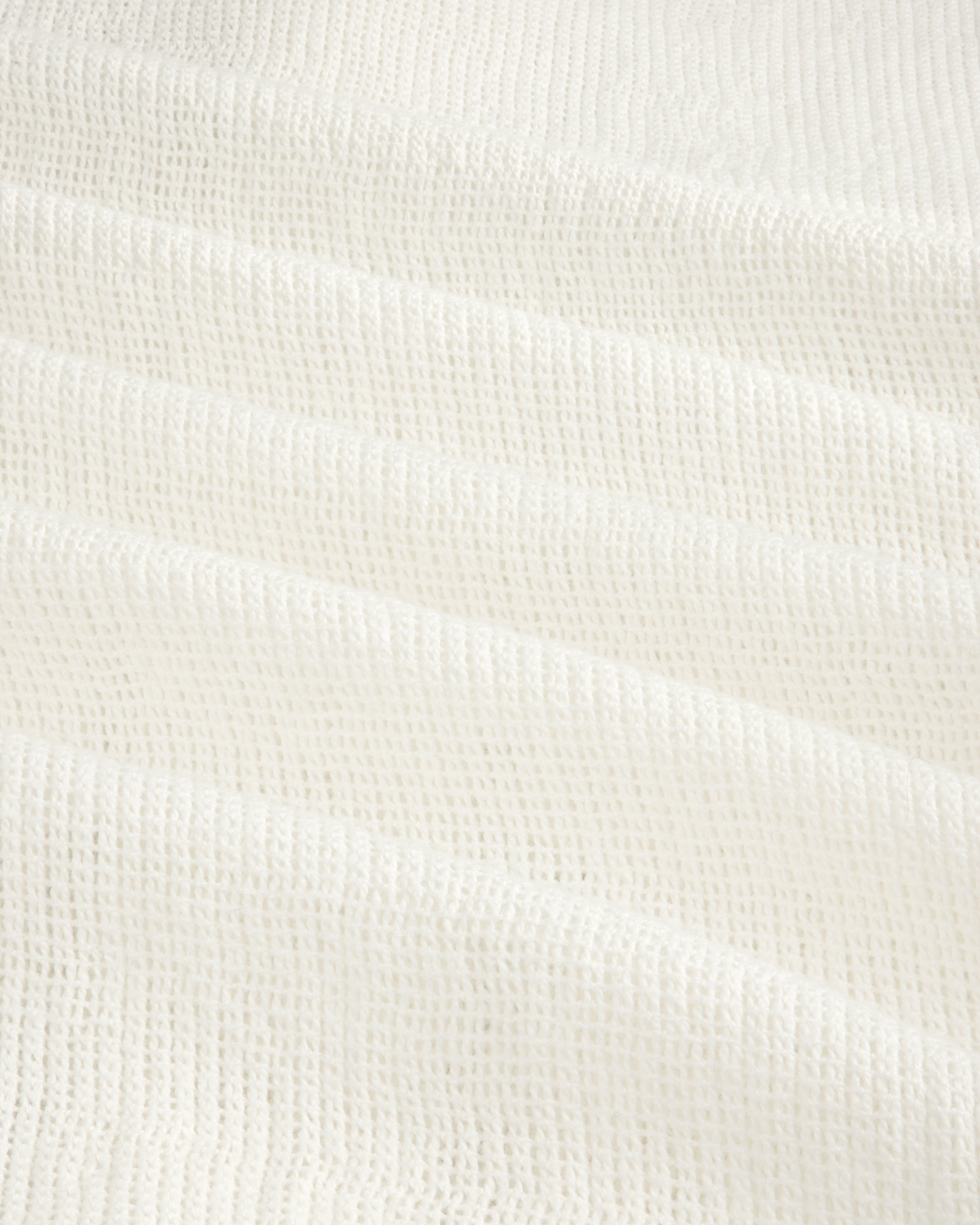 White textured waffle-weave fabric on the Mesh Jungle Shirt, shown in soft, gentle folds.