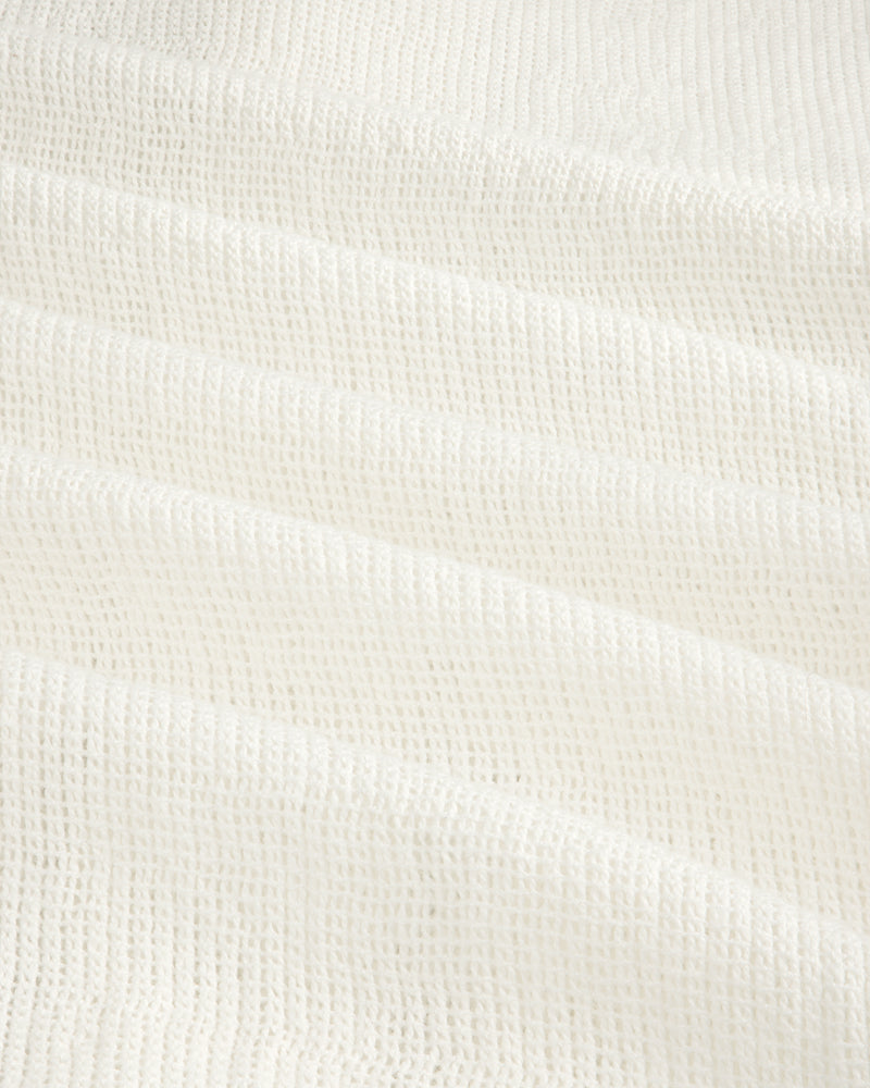 White textured waffle-weave fabric on the Mesh Jungle Shirt, shown in soft, gentle folds.
