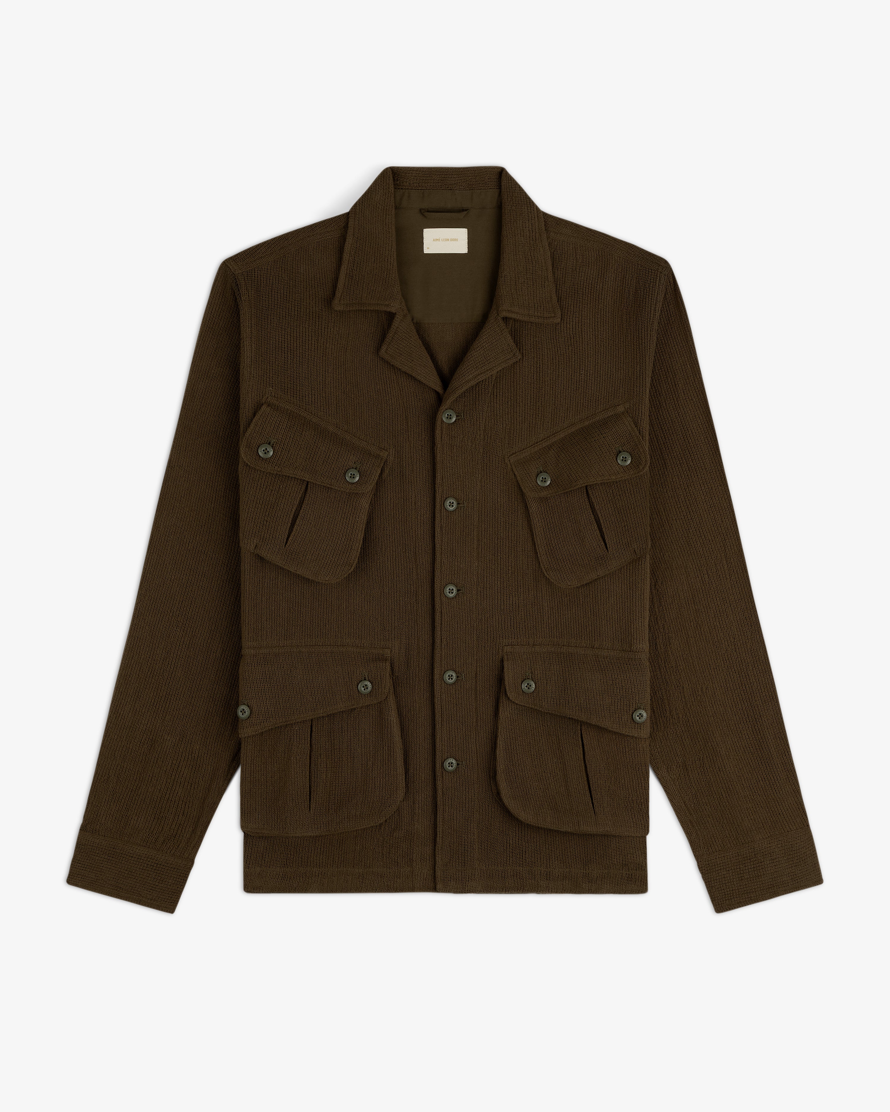 Mesh Jungle Shirt in dark brown, button-up, with four front flap pockets, displayed on a white background.