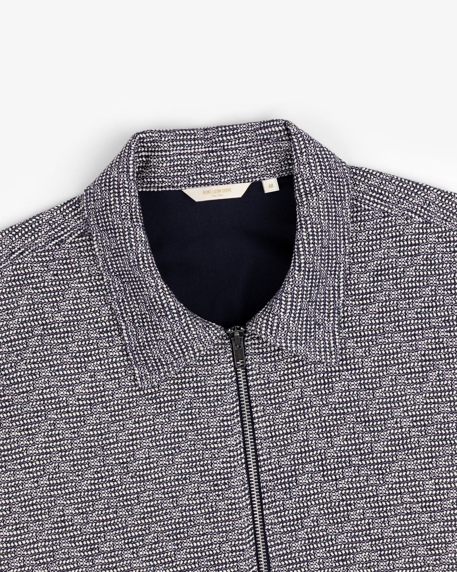 Close-up of a navy and white Textured Zip Shirt with a collar, shown on a flat white background.