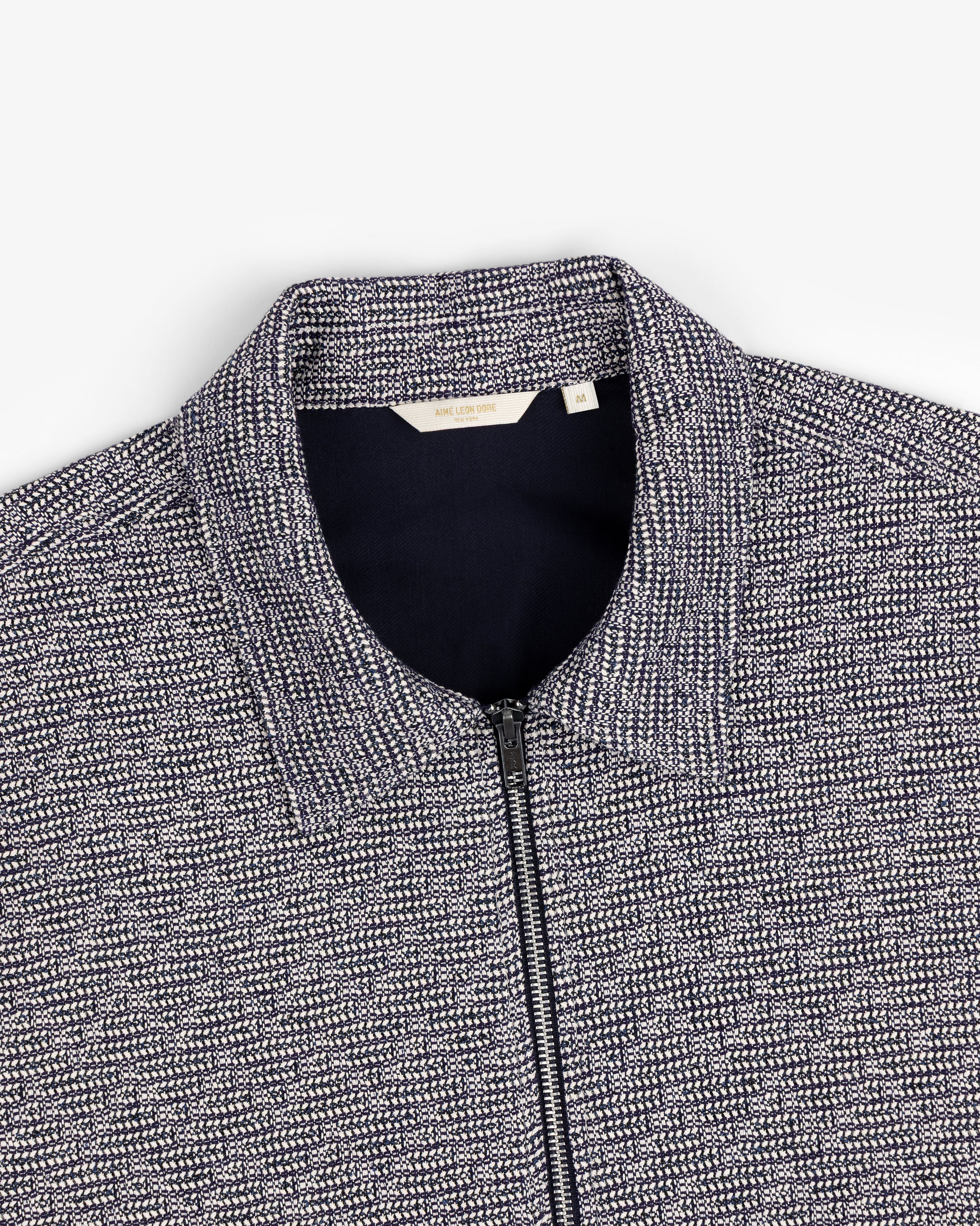 Close-up of a navy and white Textured Zip Shirt with a collar, shown on a flat white background.
