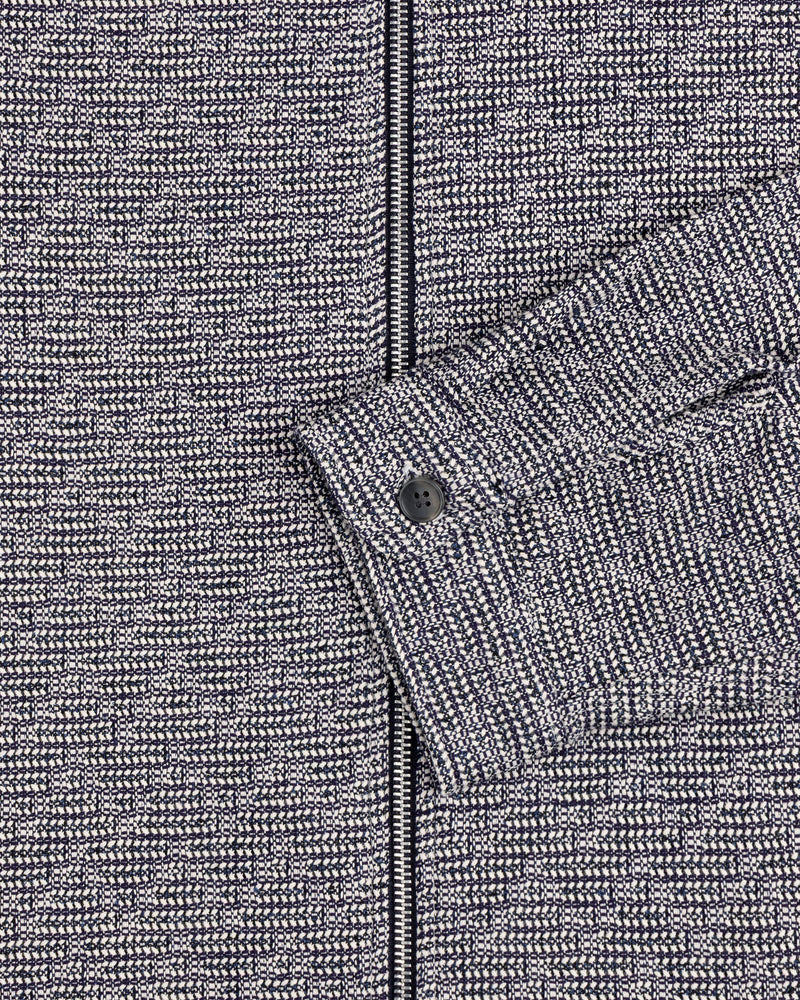 Close-up of the Textured Zip Shirt in gray and black with a buttoned cuff and visible zipper.