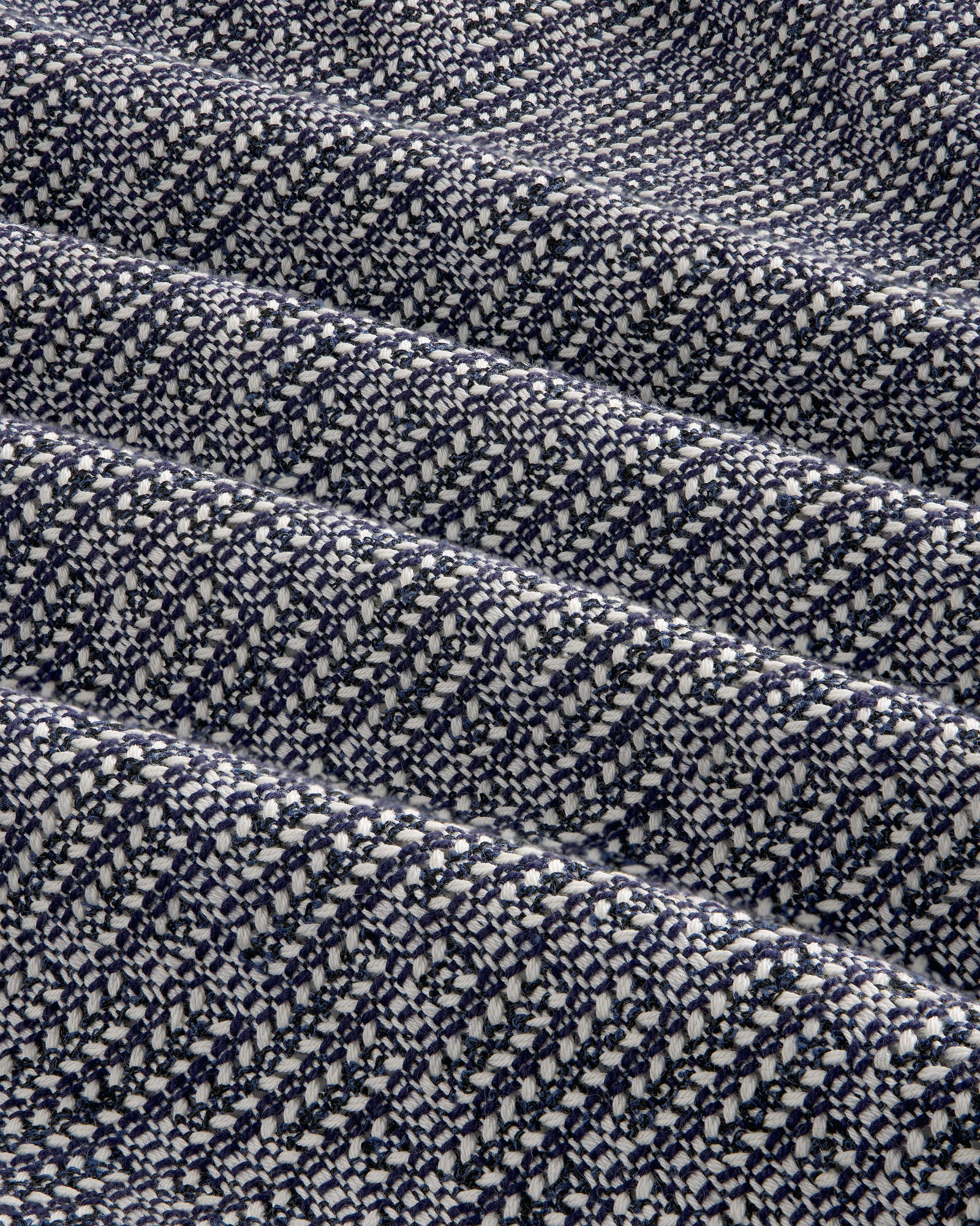 Close-up of the Textured Zip Shirt in navy blue and white woven fabric with a diagonal checkered pattern.