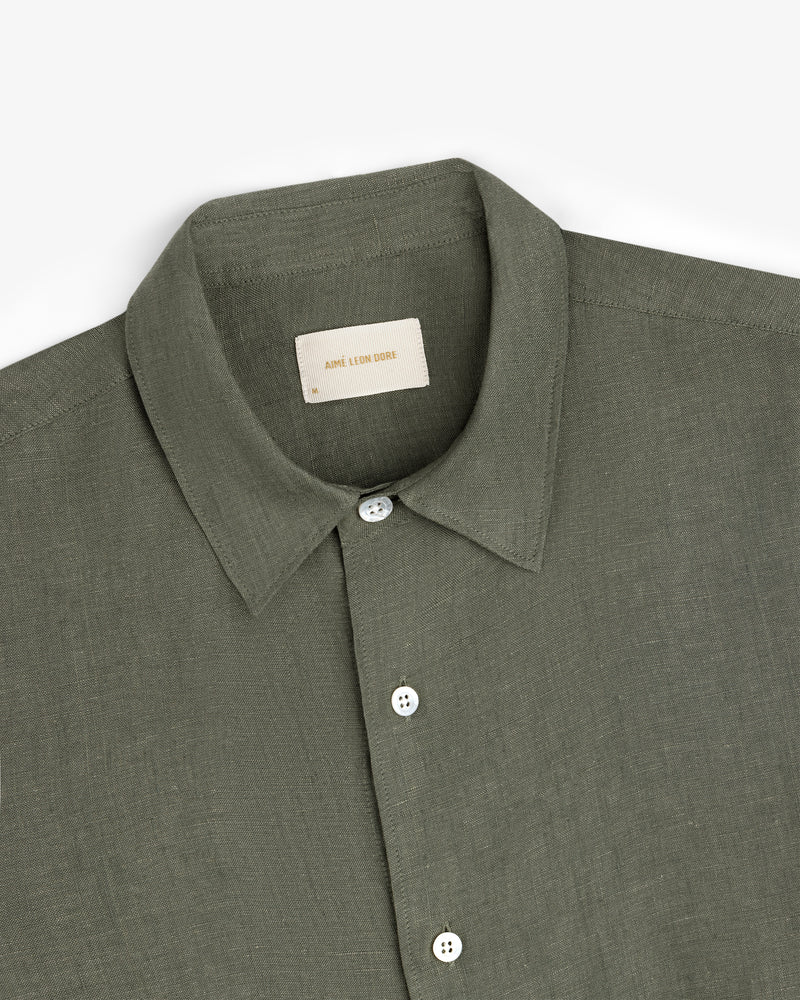 Long-Sleeve Linen Shirt in olive green with a collar and white buttons, folded neatly on a white background.