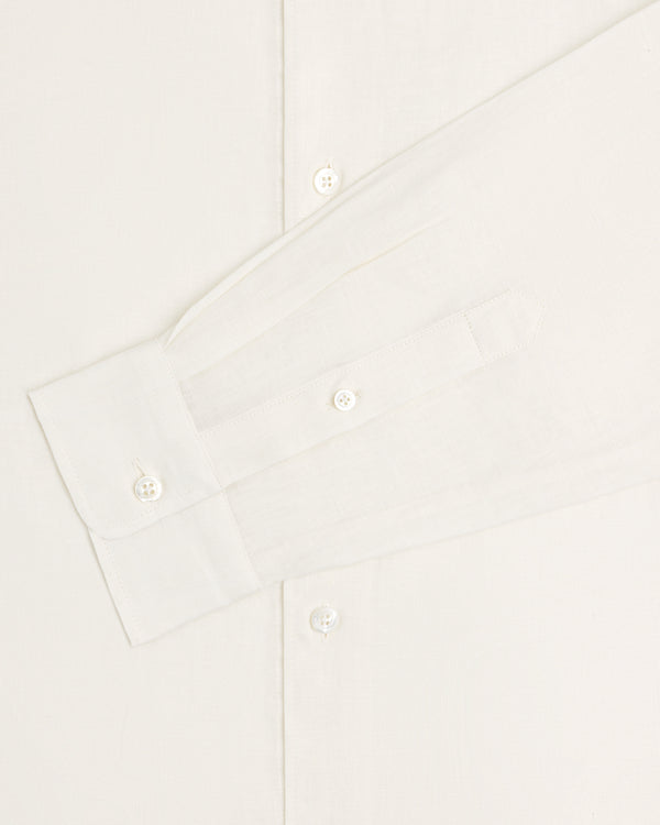 A close-up of the Long-Sleeve Linen Shirt in white, showing its buttons and cuff against a plain background.