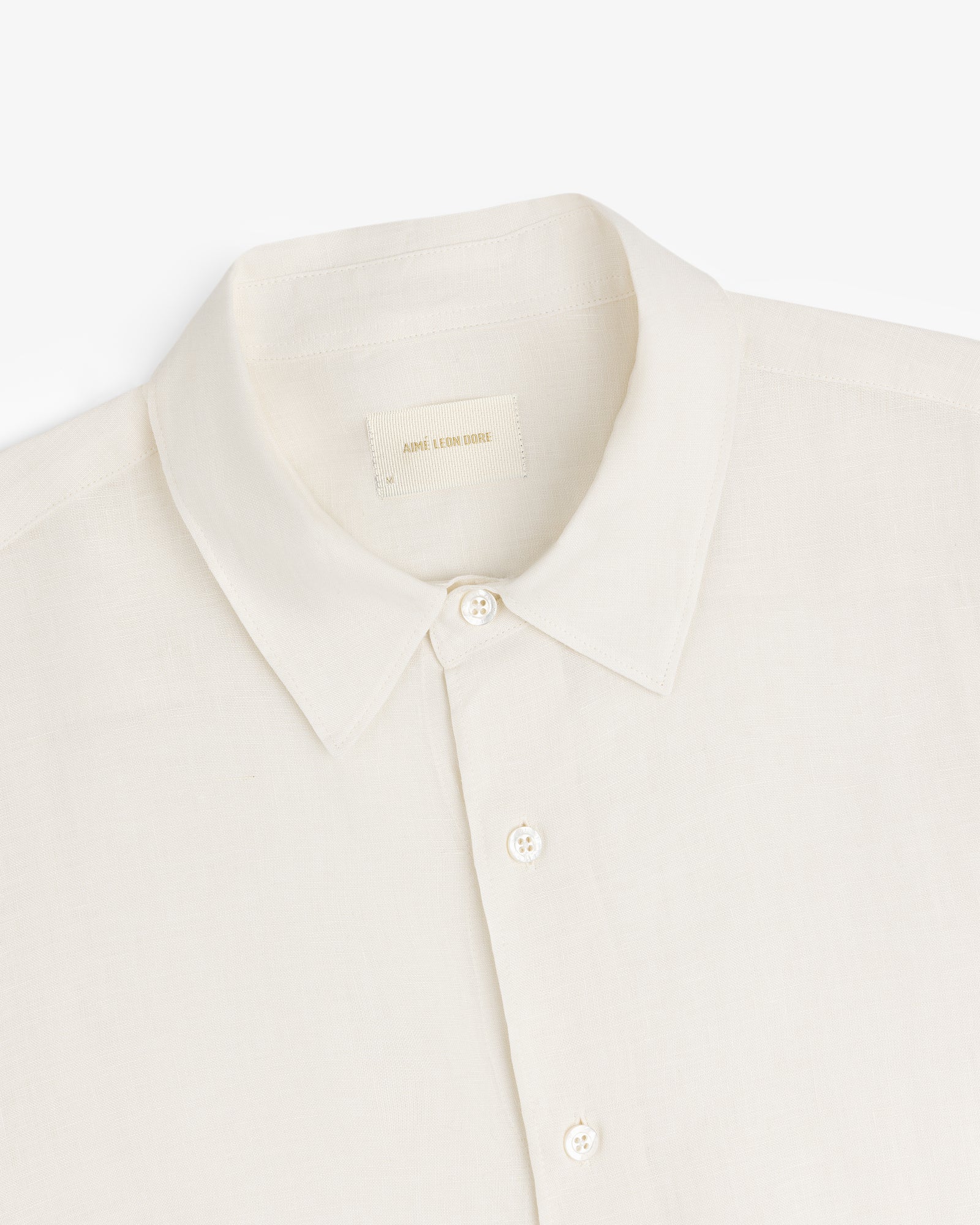 Cream-colored Long-Sleeve Linen Shirt with a collar and buttons, made of lightweight fabric, shown on white background.