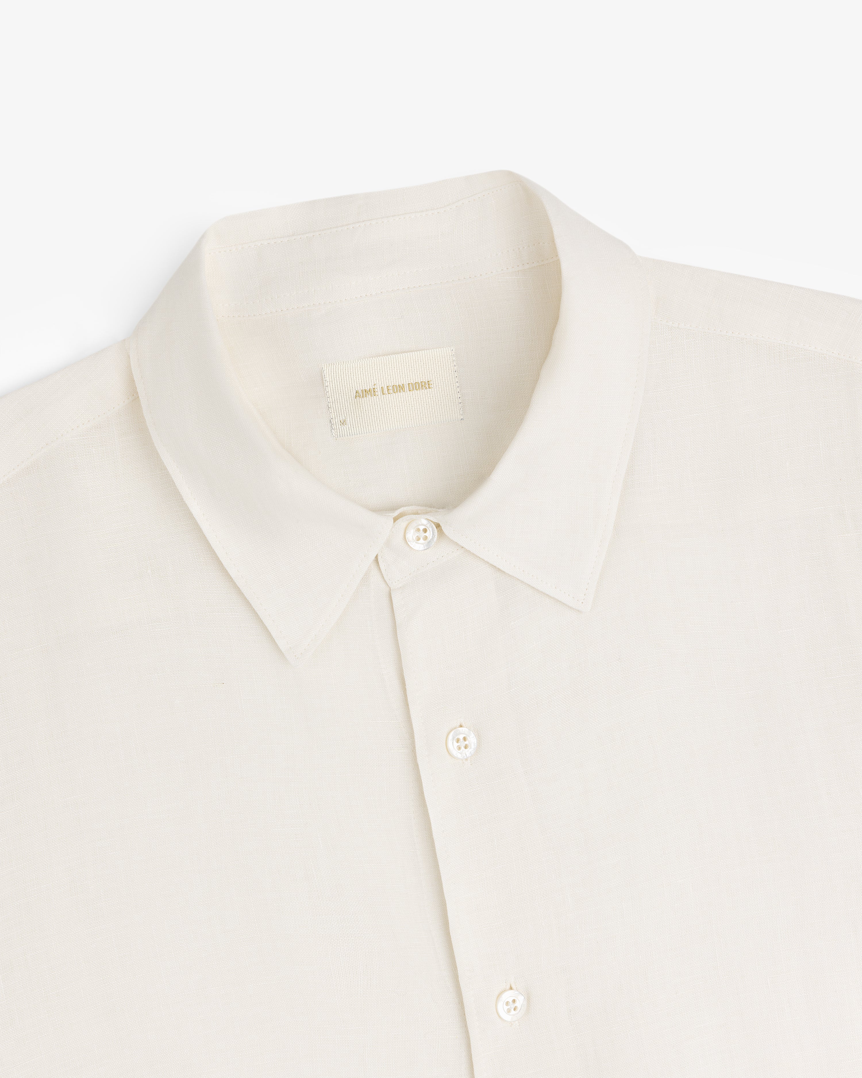 Cream-colored Long-Sleeve Linen Shirt with a collar and buttons, made of lightweight fabric, shown on white background.