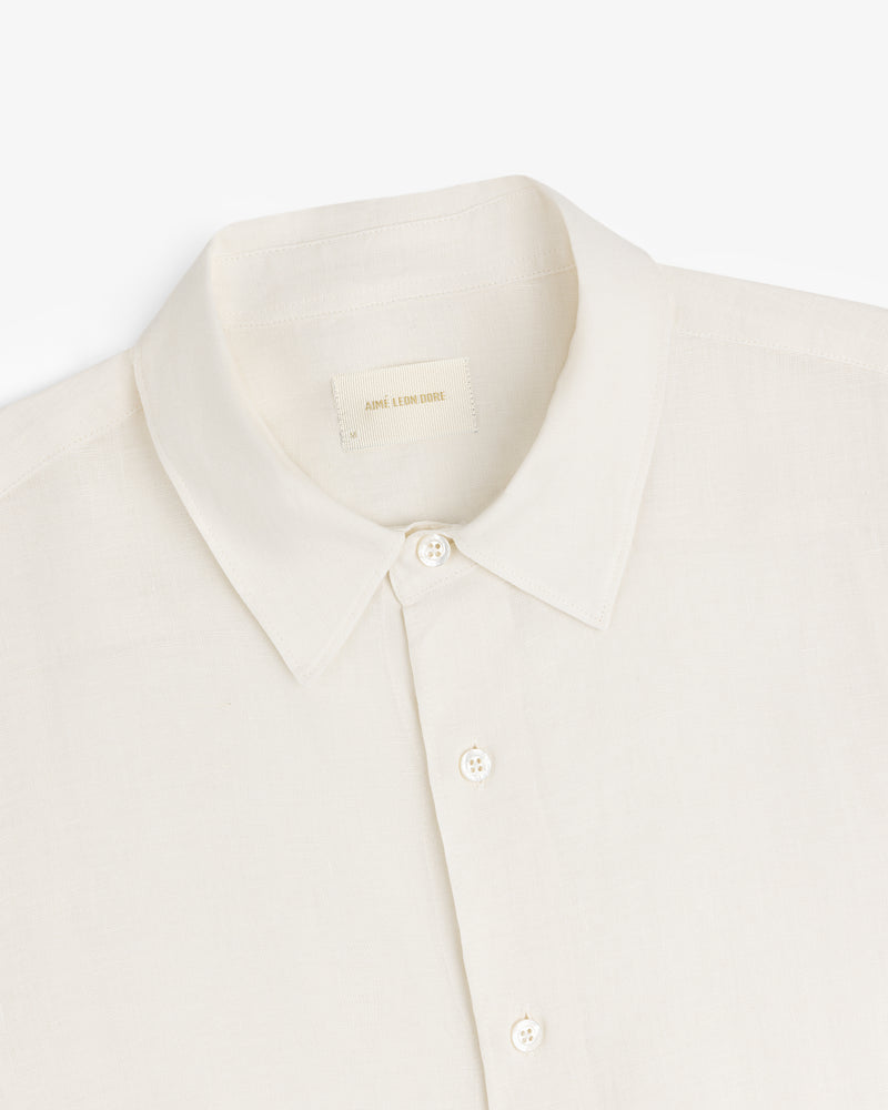 Cream-colored Long-Sleeve Linen Shirt with a collar and buttons, made of lightweight fabric, shown on white background.