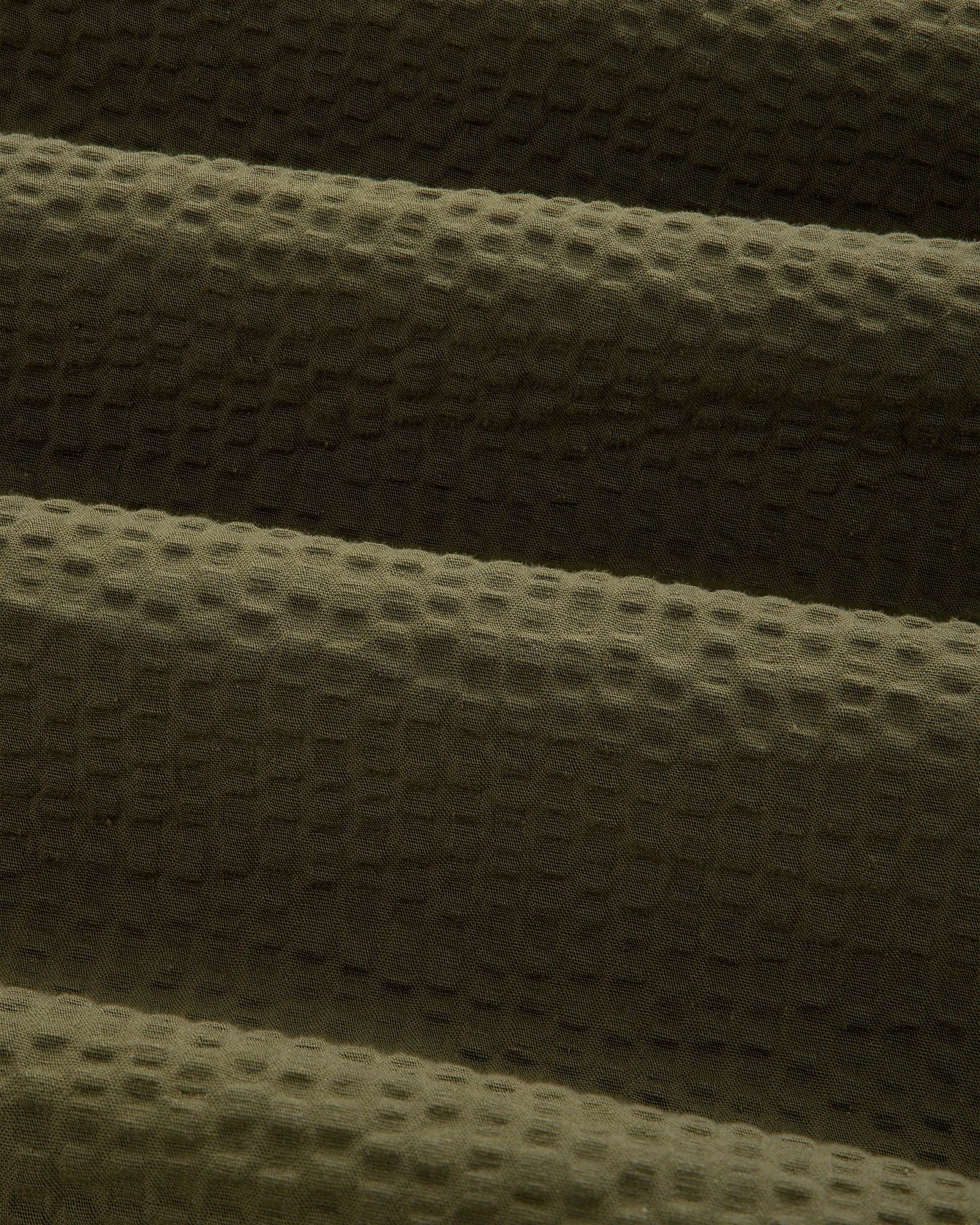 Close-up of olive green seersucker fabric on the Short-Sleeve Seersucker Shirt, highlighting its soft, ridged texture.