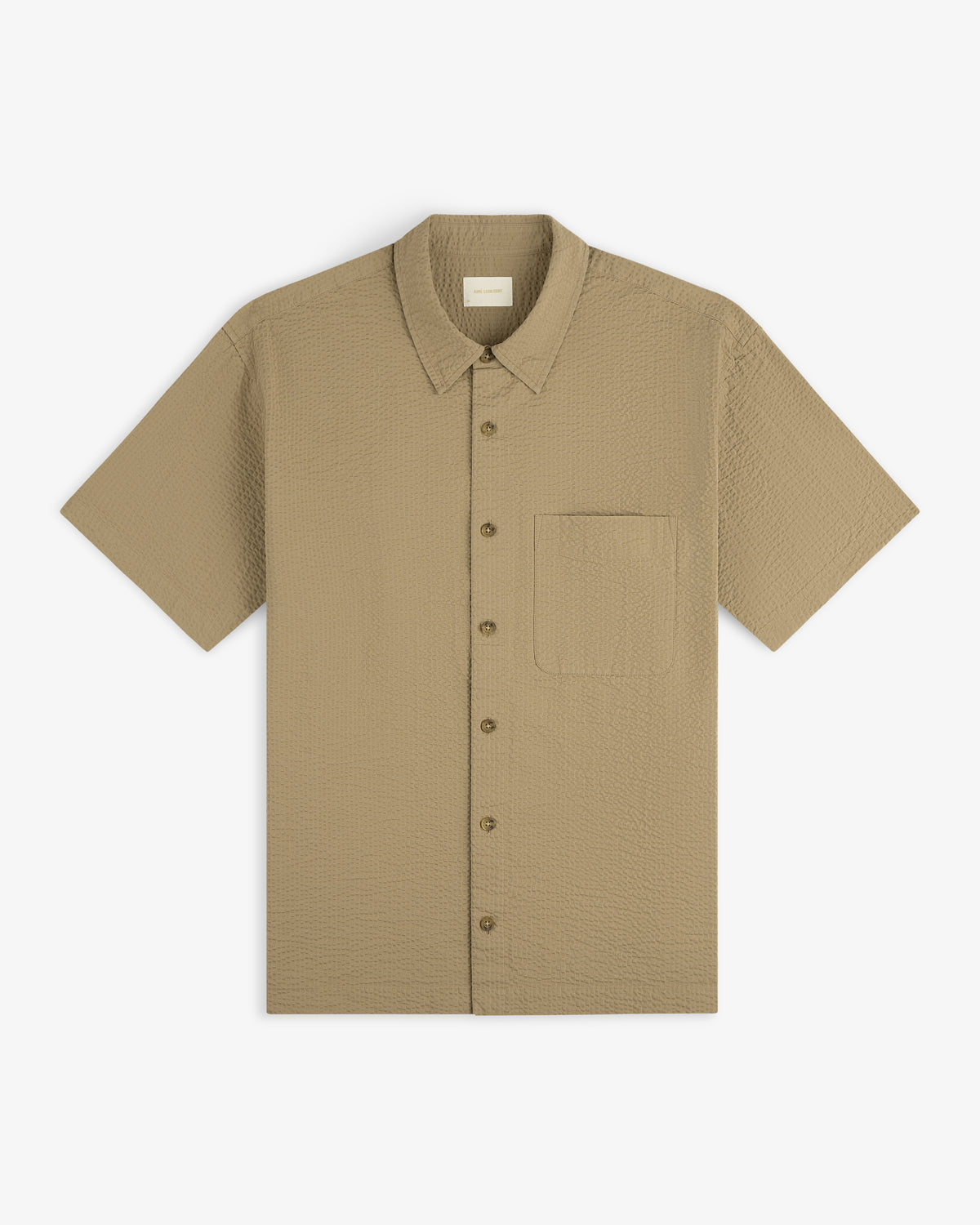 Short-Sleeve Seersucker Shirt in light brown with a chest pocket, laid flat on a white background.