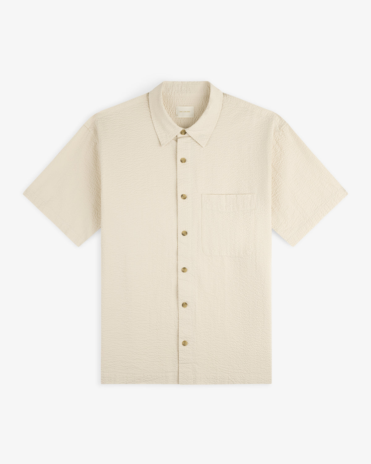 Short-Sleeve Seersucker Shirt in beige with a chest pocket, button-up, shown laid flat on a white background.