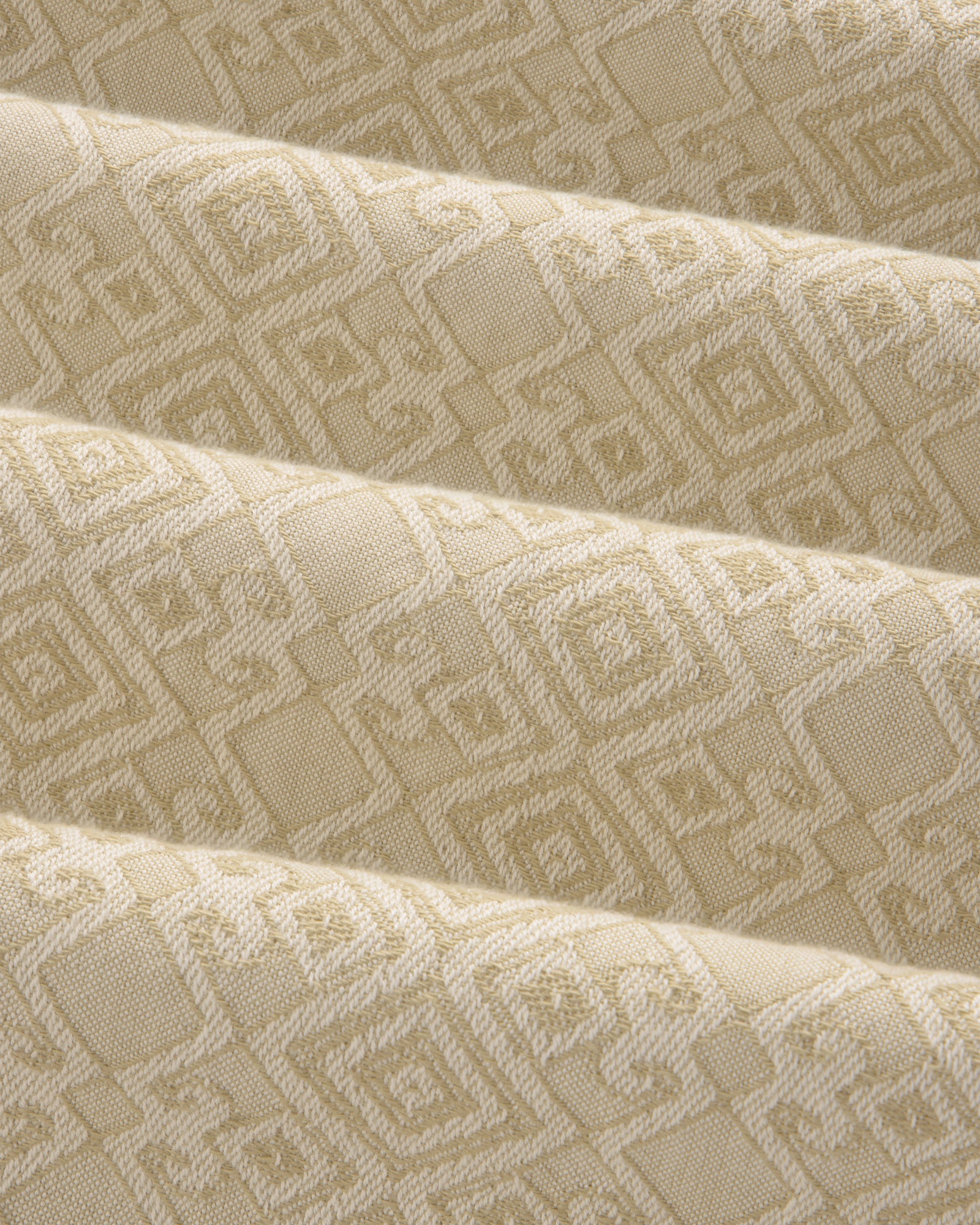 Jacquard Leisure Shirt in beige fabric with a subtle geometric pattern of squares and diamonds, shown with gentle folds.