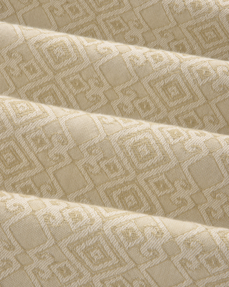 Jacquard Leisure Shirt in beige fabric with a subtle geometric pattern of squares and diamonds, shown with gentle folds.
