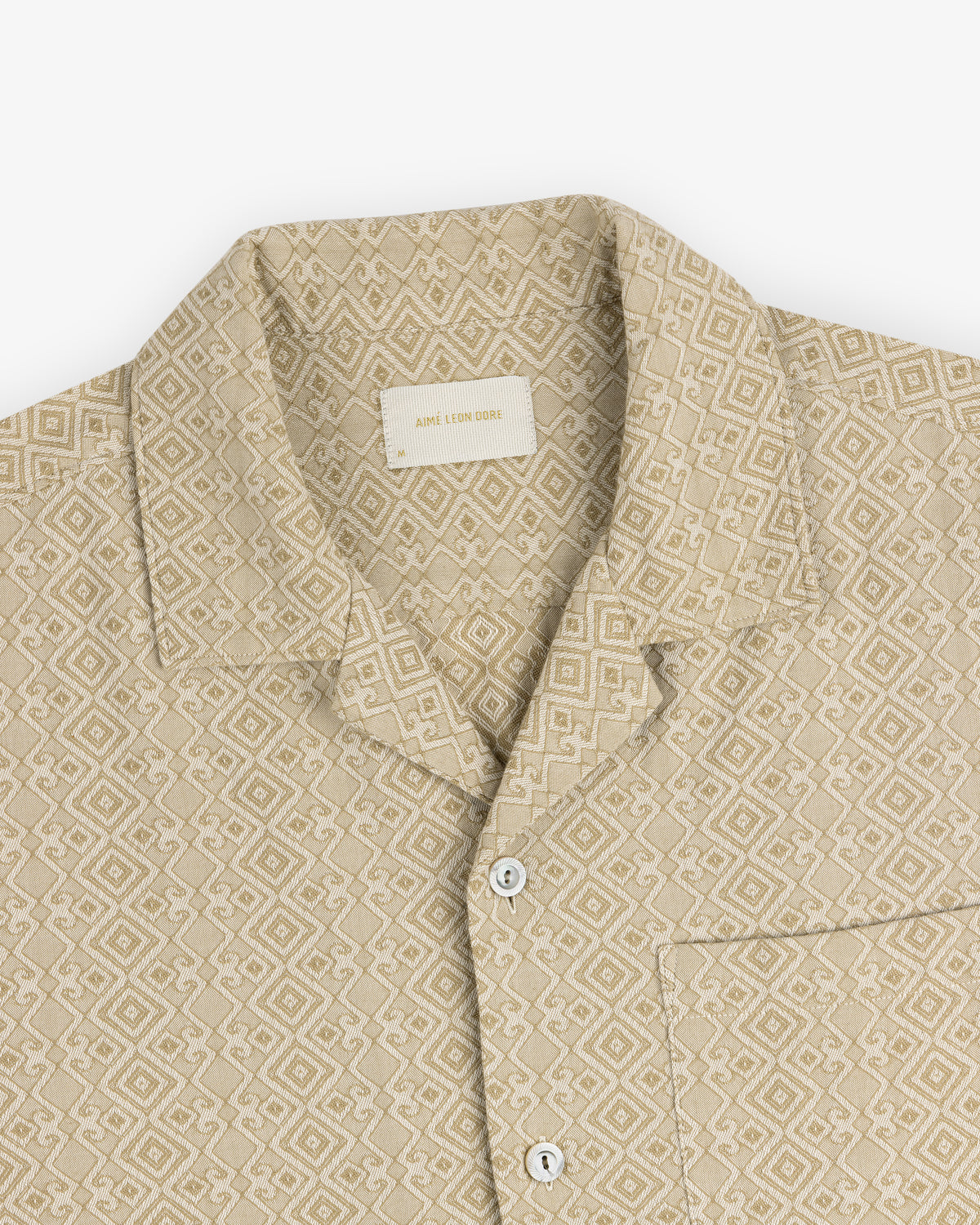 Jacquard Leisure Shirt: beige with geometric diamond pattern, short collar, white buttons, and chest pocket.