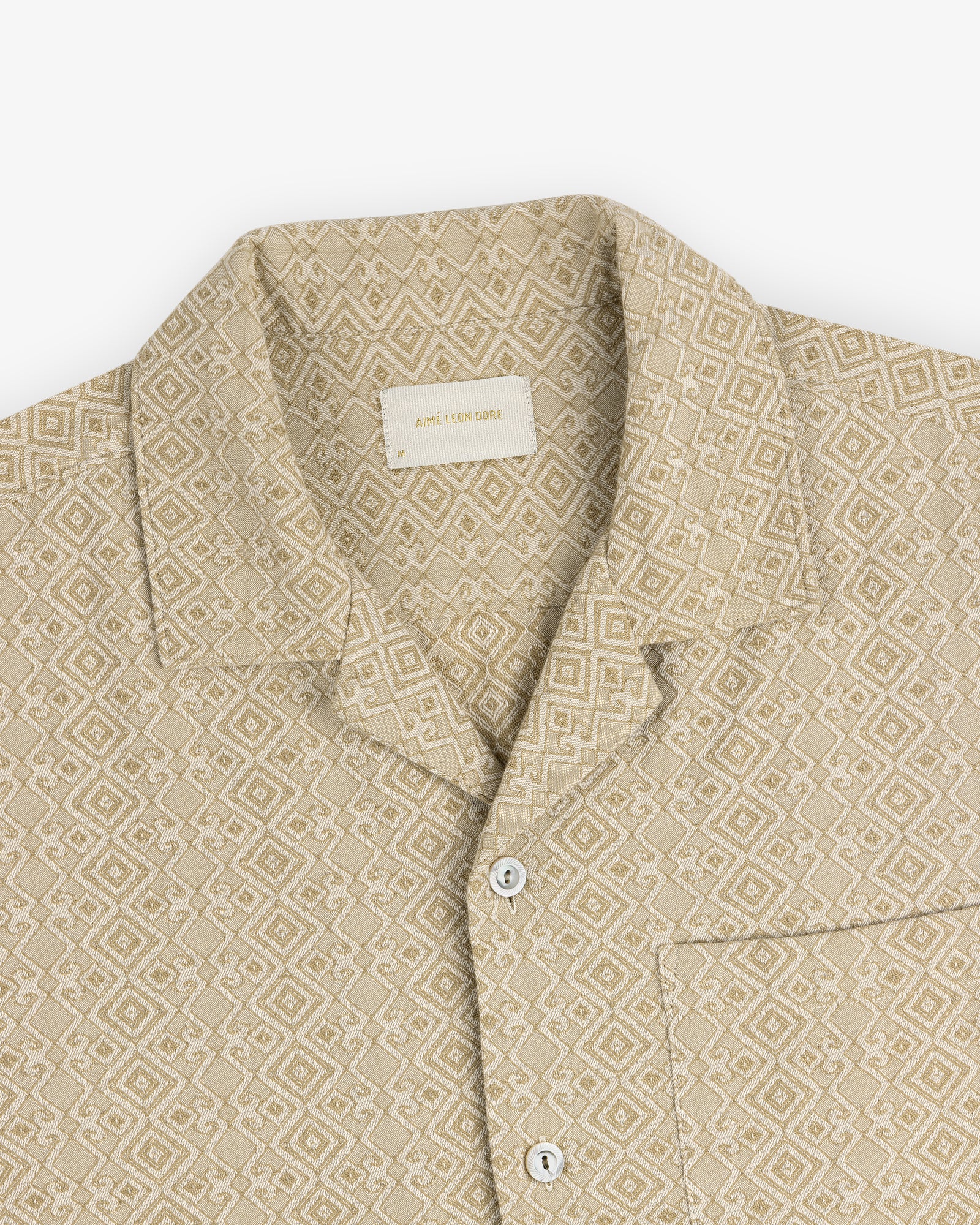 Jacquard Leisure Shirt: beige with geometric diamond pattern, short collar, white buttons, and chest pocket.
