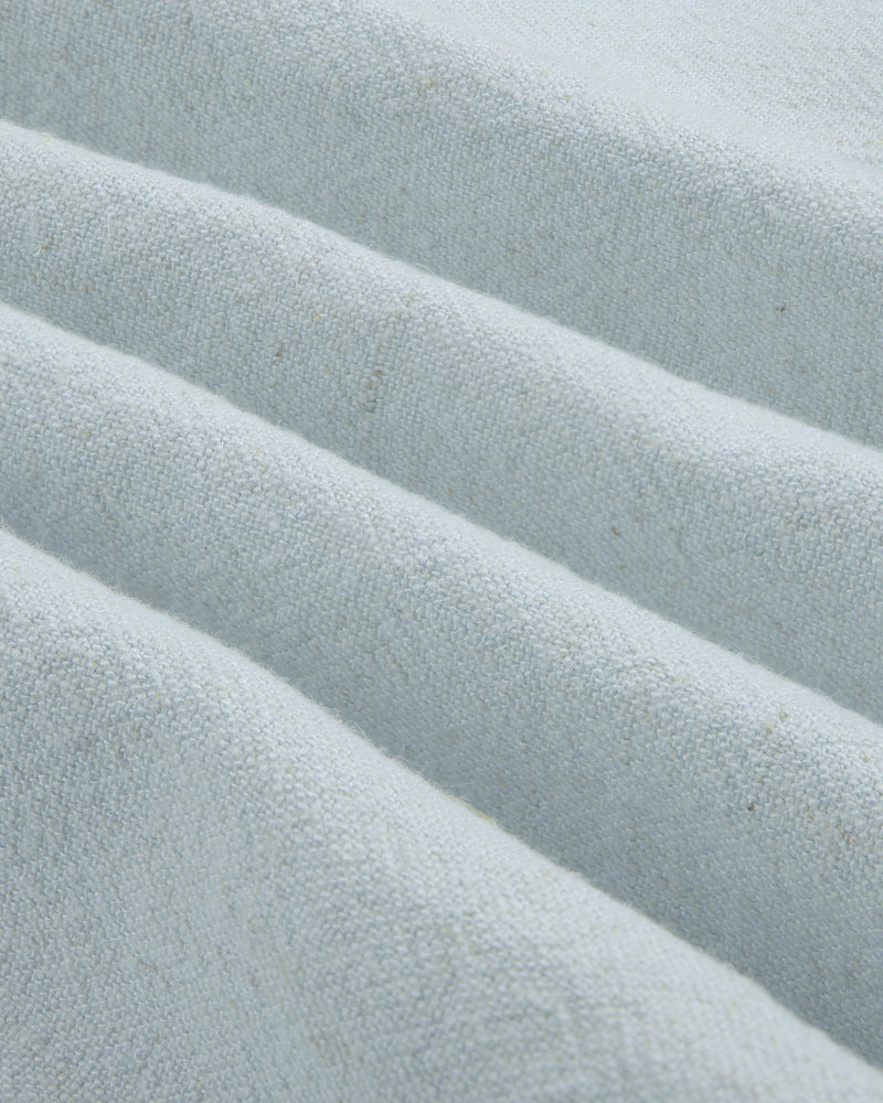 Close-up of the Linen Blend Leisure Shirt in light gray with textured fabric folded into neat, diagonal pleats.