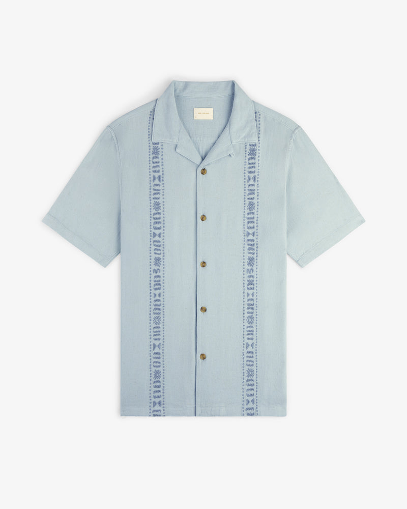 Linen Blend Leisure Shirt: light blue, short sleeves, collared, button-up with vertical embroidered front patterns.