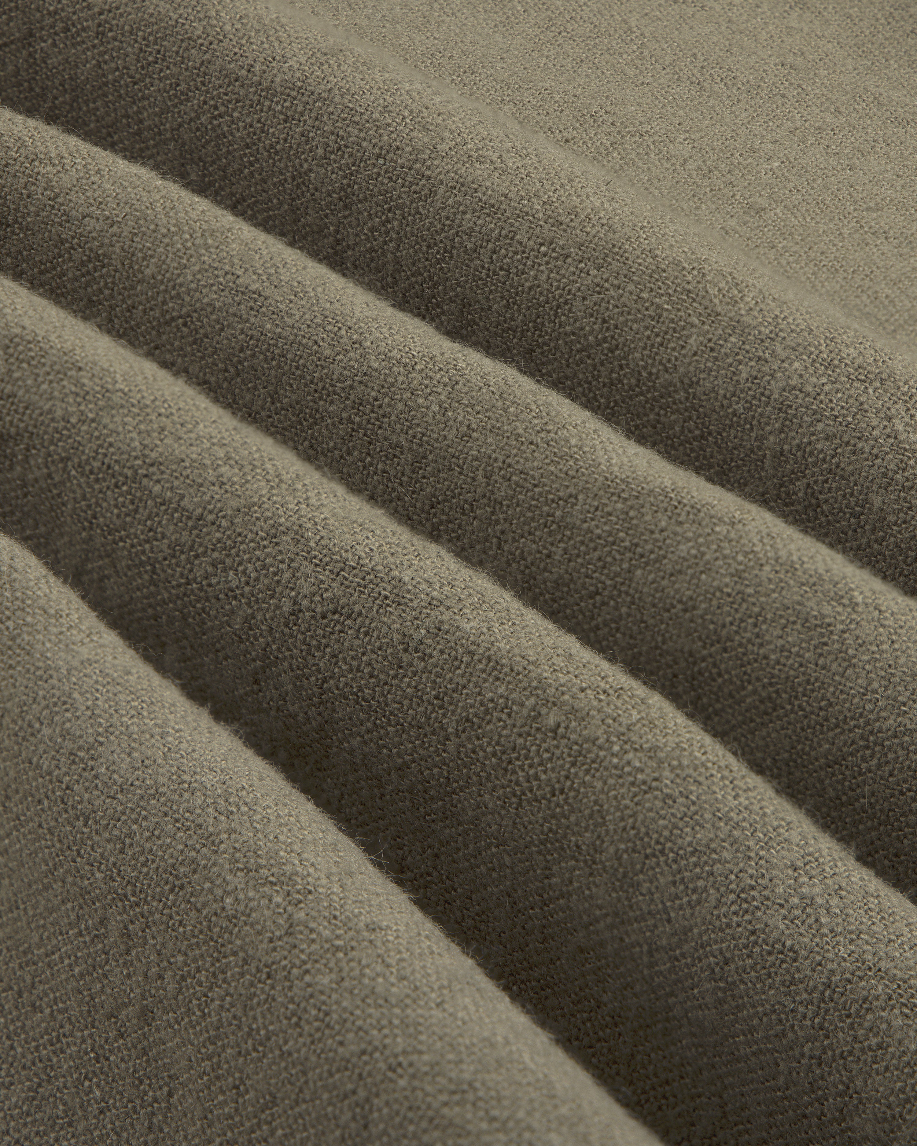 Close-up of the Linen Blend Leisure Shirt’s soft, brownish-grey fabric with gentle folds and textured weave.