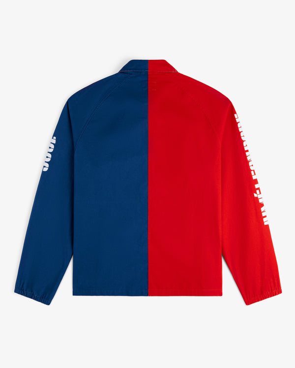 Back view of the Marina Jacket, a long-sleeve split vertically in blue and red with white text on both sleeves.