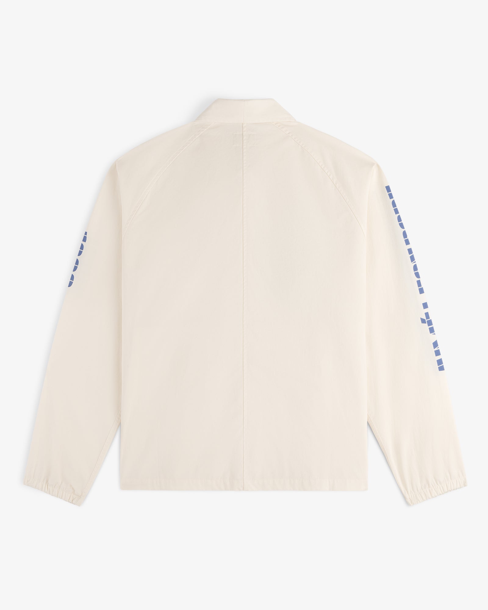 Back view of the Marina Jacket, a cream-colored design featuring blue square patterns along both sleeves.