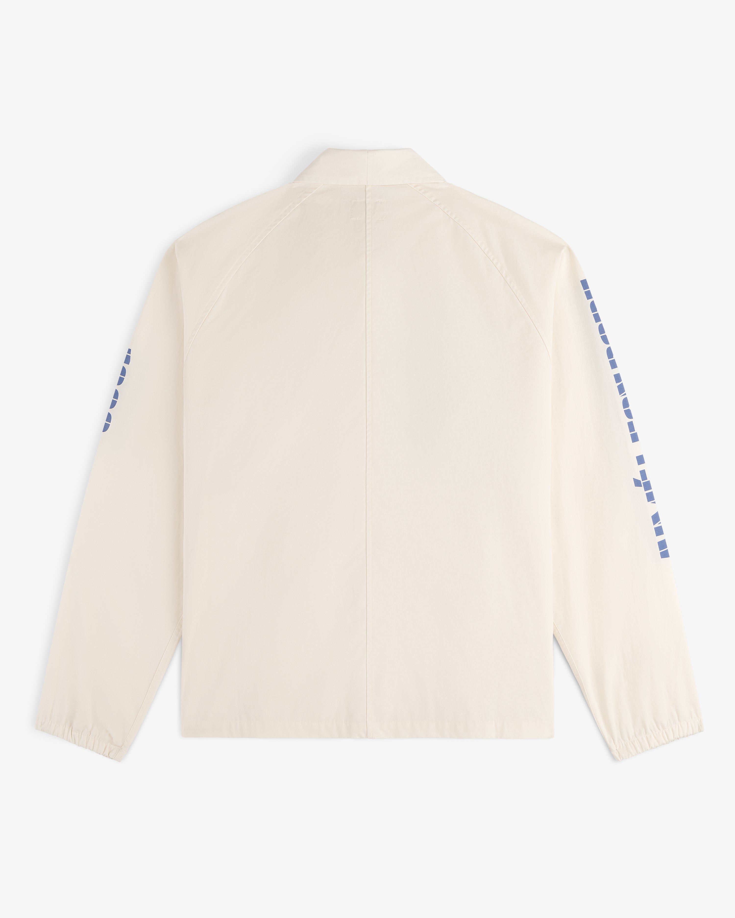 Back view of the Marina Jacket, a cream-colored design featuring blue square patterns along both sleeves.